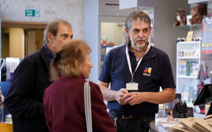 Museum volunteer talking to visitors