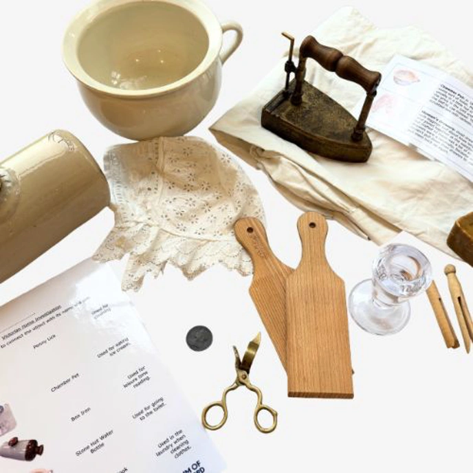 Collection of replica Victorian items, including iron, wooden clothes peg and chamber pot