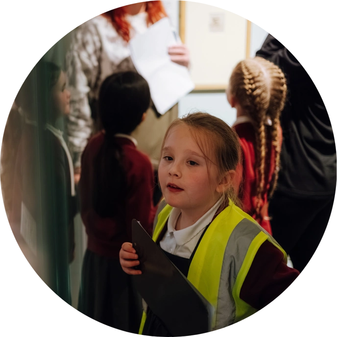Schoolgirl in Museum wearing yellow high-vi jacket